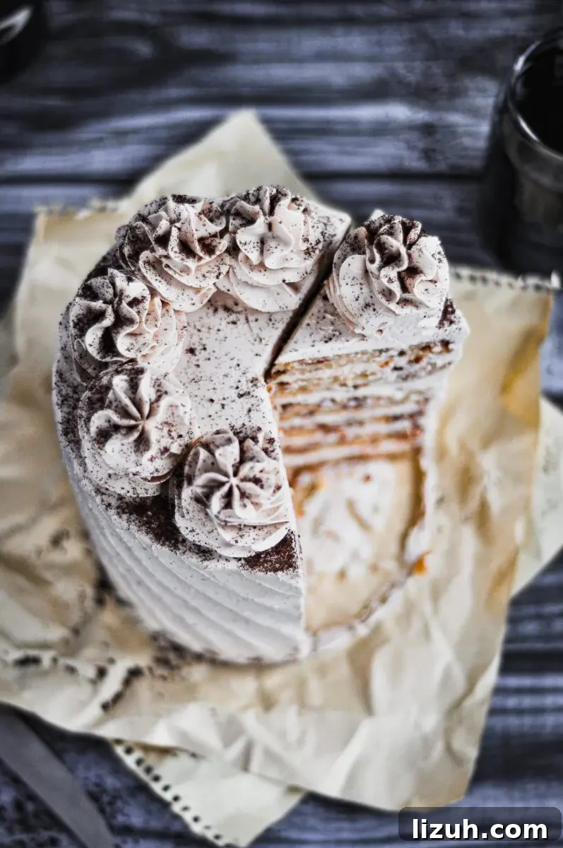 Baileys Irish Cream Cake with Gluten-Free Option 5 A light tan bailey's and coffee flavored cake topped with large buttercream swirls. There are two slices taken out of the cake.