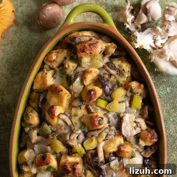 An oval casserole dish filled with wild mushroom stuffing.