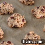 Baked chocolate chip cookies on parchment lined baking sheet