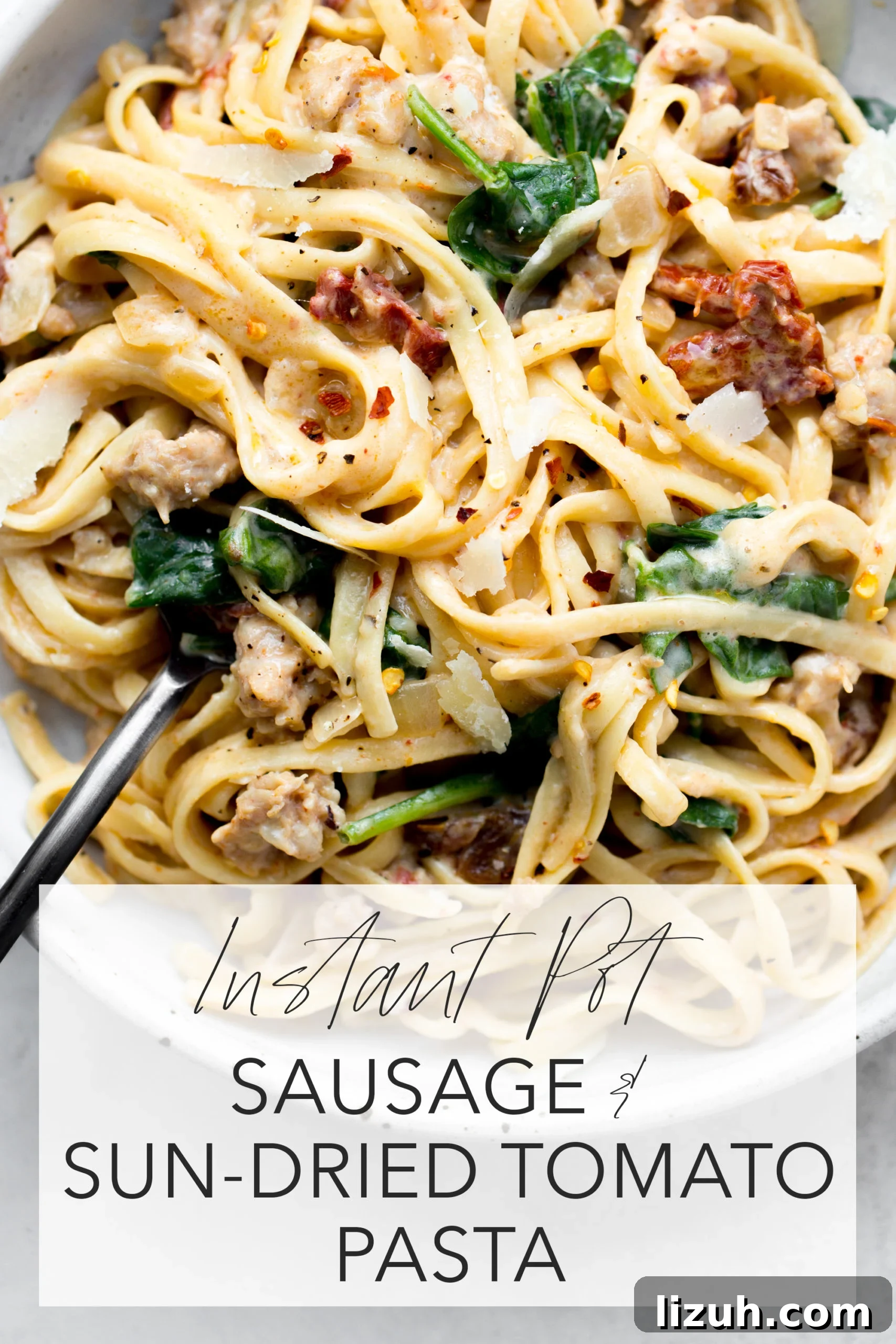 instant pot sausage sun-dried tomato pasta overhead in a gray bowl with title text overlay