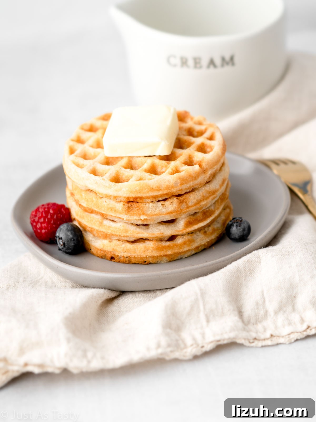 Waffles stacked on a plate.