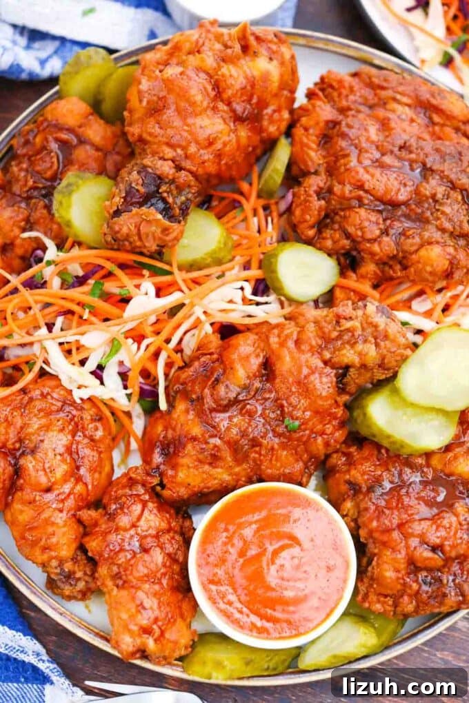 Nashville Hot Chicken: Crispy, Spicy Southern Recipe 5 overhead shot of a plate of fried nashville hot chicken served with pickles and dipping sauce
