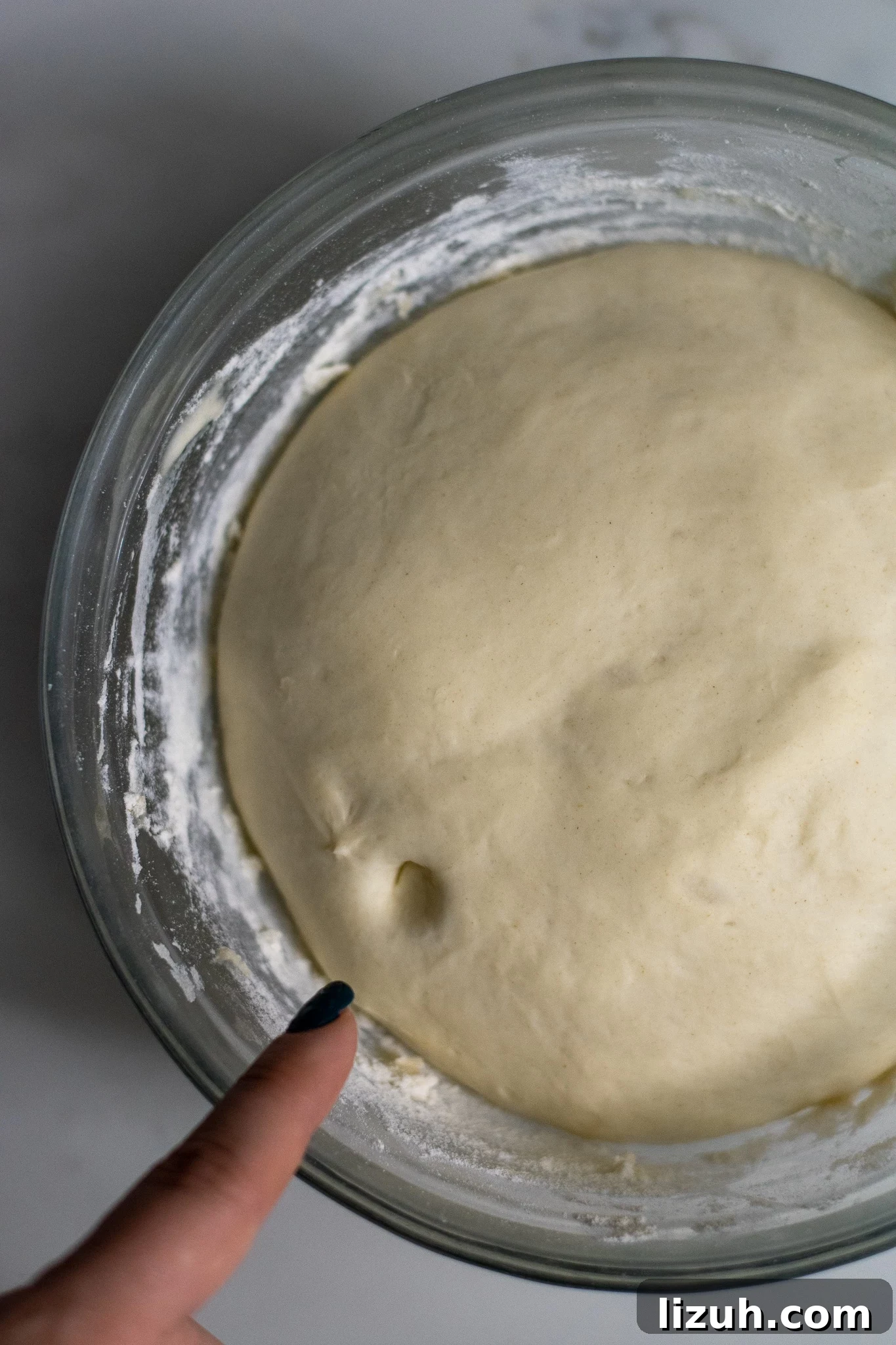 Answers to Your Top FAQs: Quick Solutions to Common Questions 2 Trying the poke test on dough that has risen.
