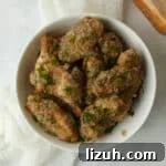 Air Fryer Garlic Parmesan Wings tossed in a sauce with fresh Parmesan Cheese.