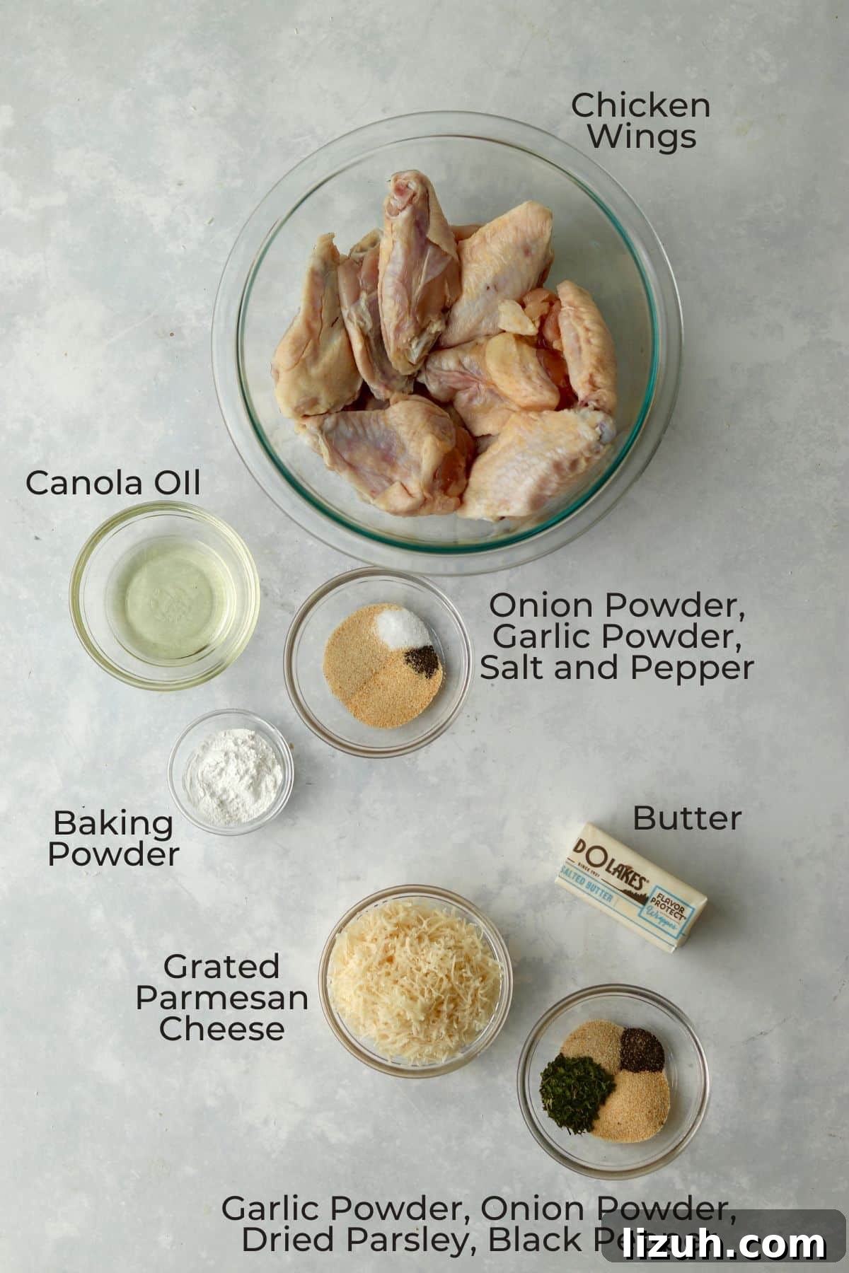 Crispy Garlic Parmesan Air Fryer Chicken Wings 3 Chicken wings, oil, spices, butter, and Parmesan Cheese in glass prep bowls.