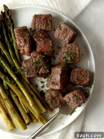 steak bites with asparagus on a plate