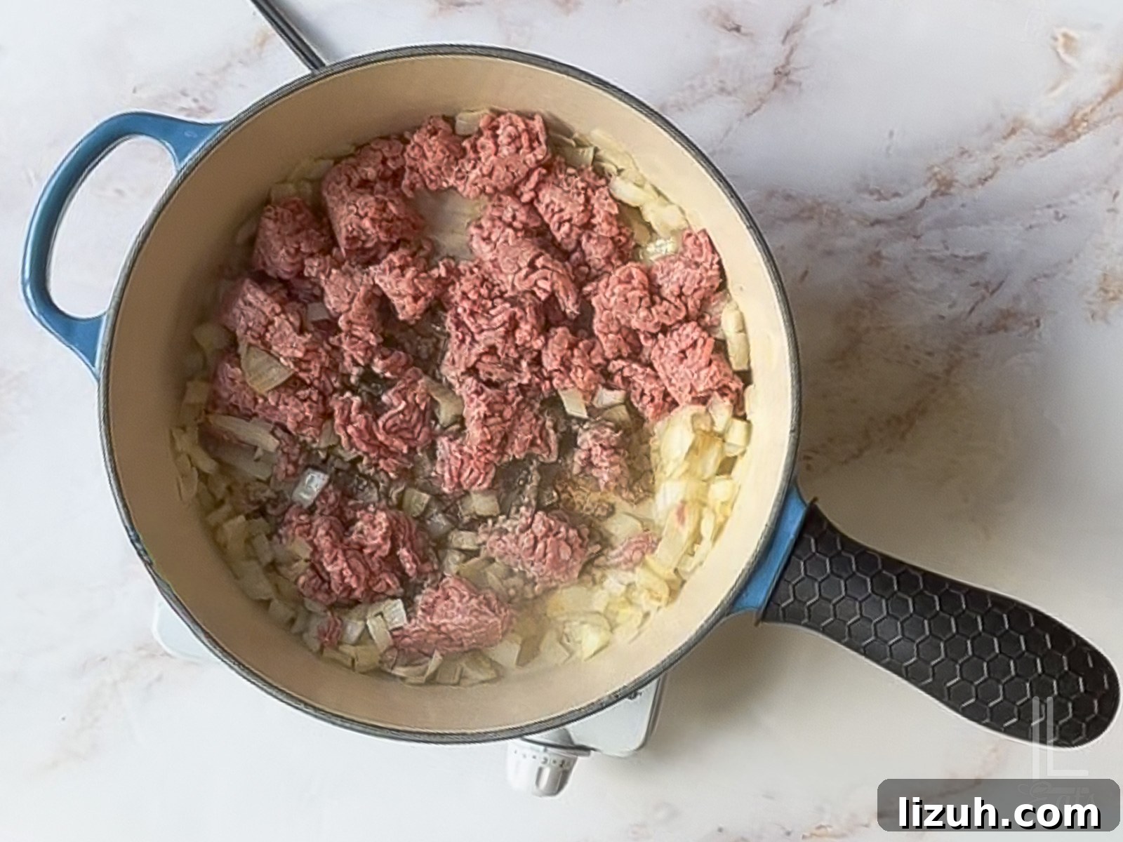 One-Pot Taco Mac and Cheese Recipe for Quick Weeknight Dinners 6 browning ground beef and onion in a large skillet.
