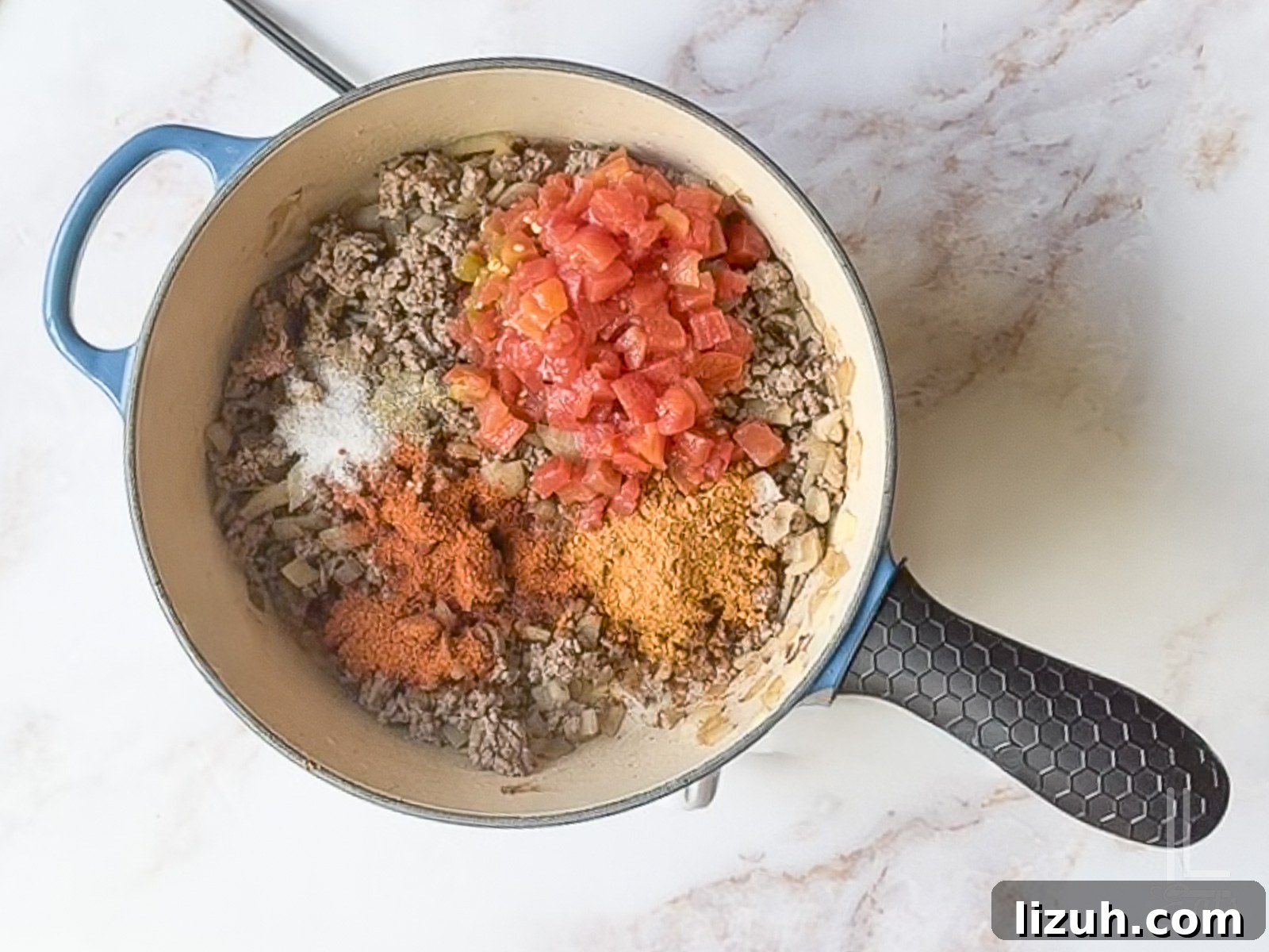 One-Pot Taco Mac and Cheese Recipe for Quick Weeknight Dinners 7 added rotel and spices to the ground beef mixture.