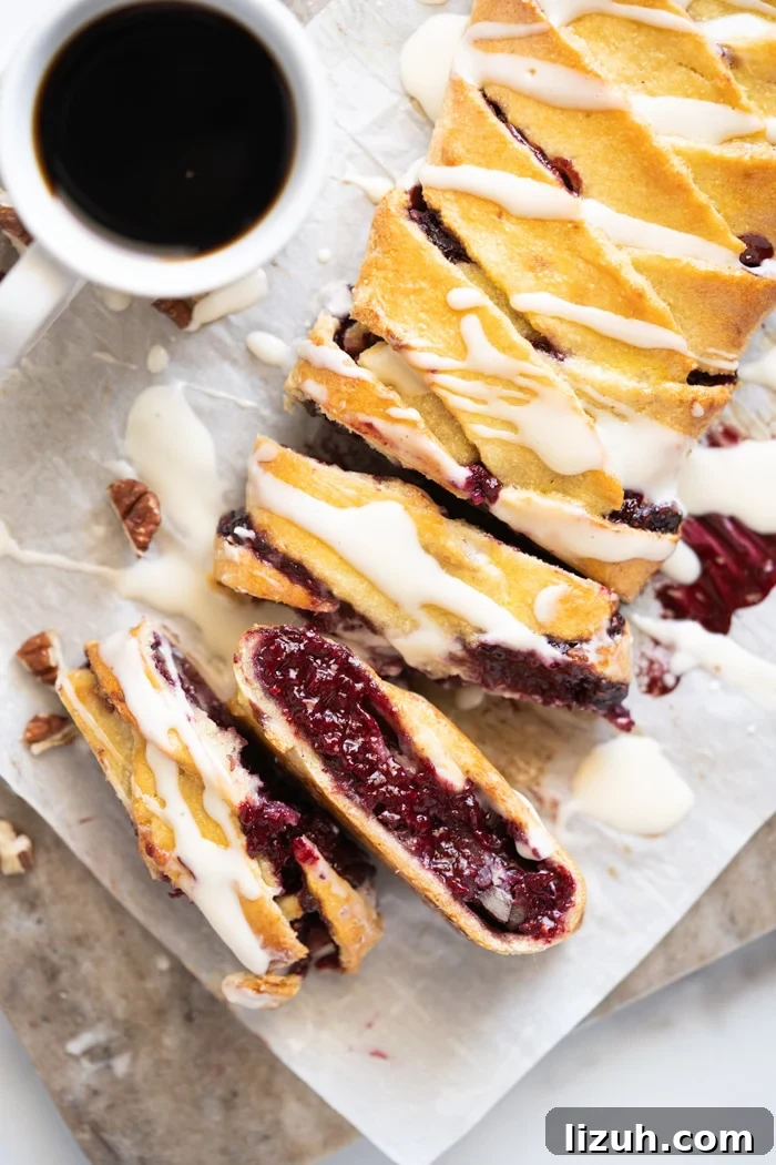 Sliced keto danish with cream cheese glaze and a mug of coffee