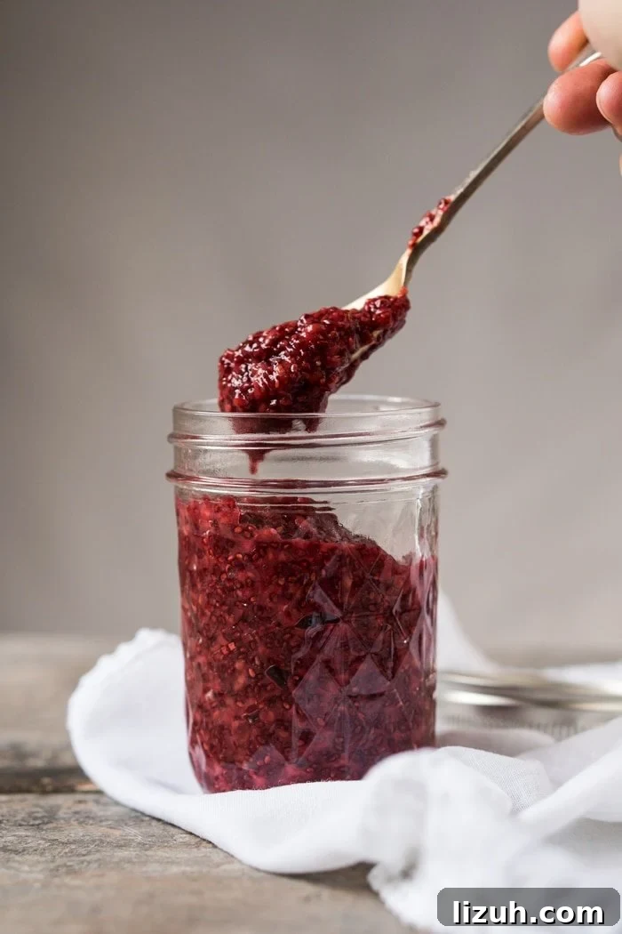 Taking a spoonful of keto raspberry chia jam