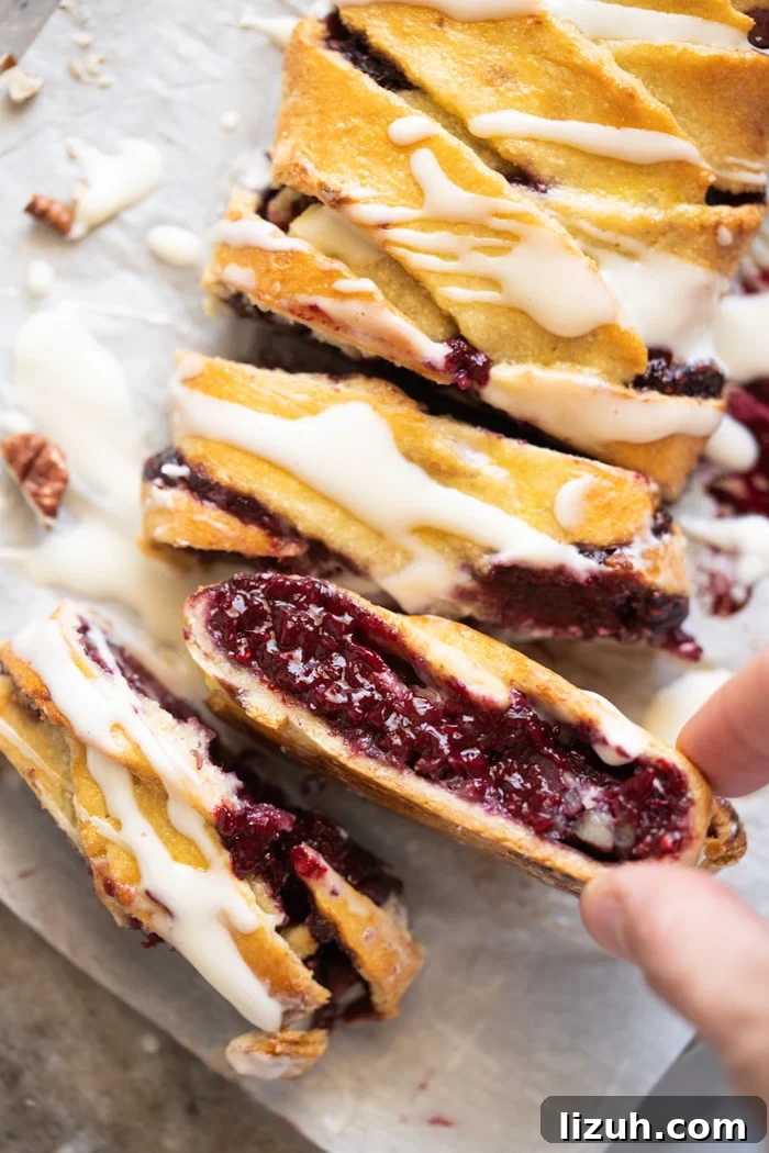 Taking a slice of keto danish with raspberry chia jam filling