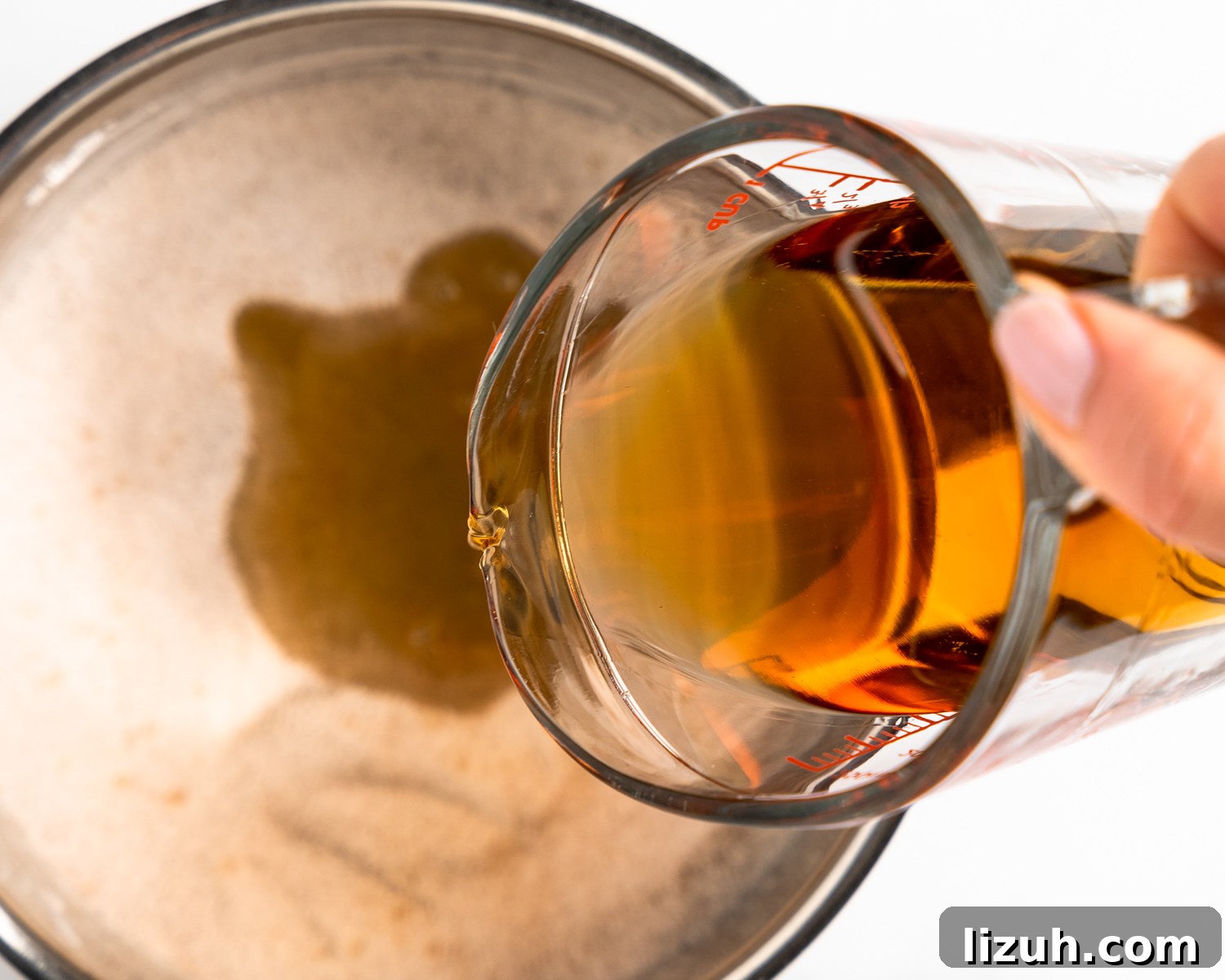 Bourbon poured into a pan to make peach bourbon sauce
