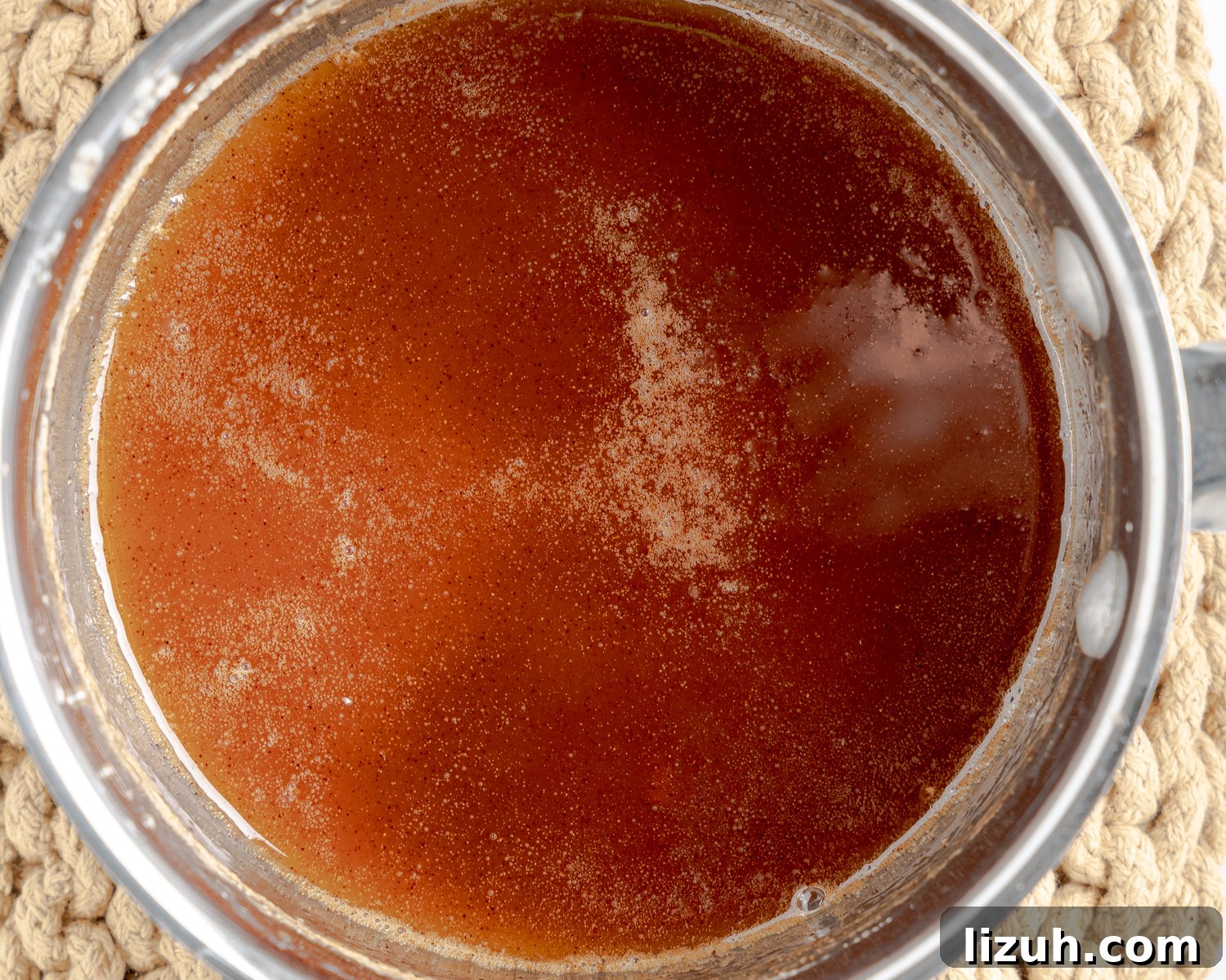 A pan of simmering bourbon sauce