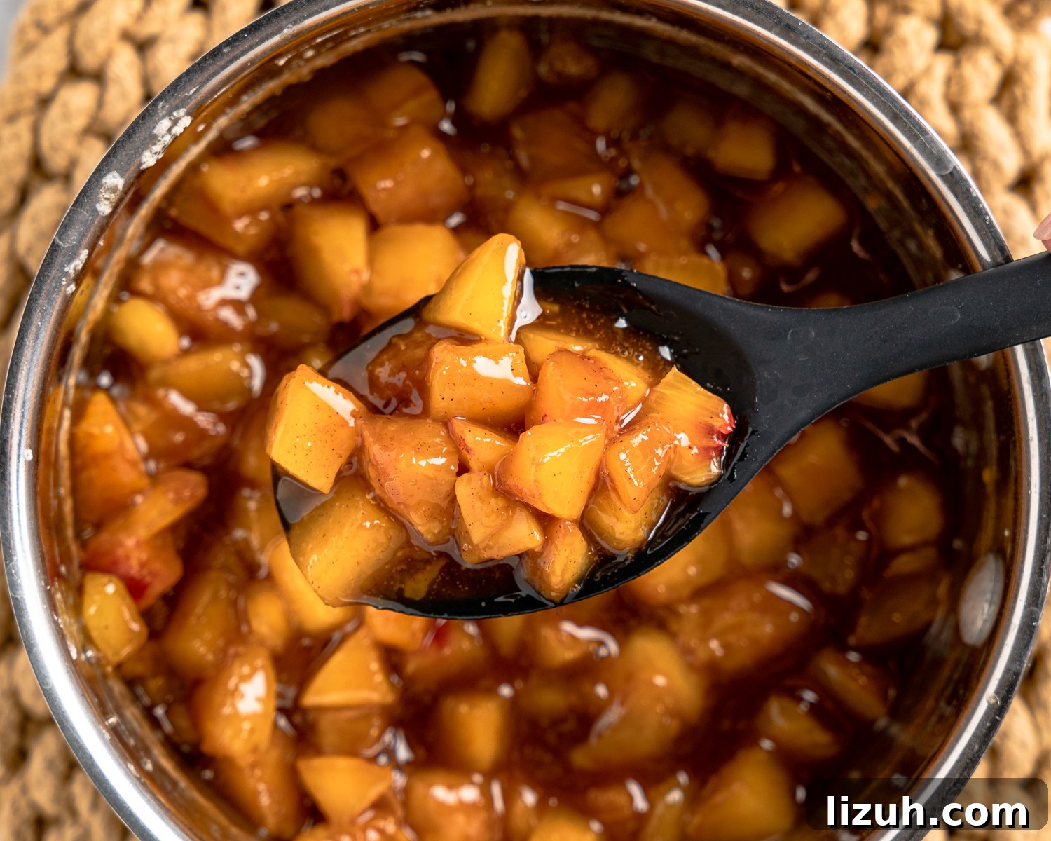 Fresh peaches added to bourbon sauce.