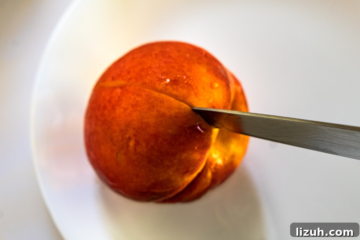 A peach being scored with a sharp knife.