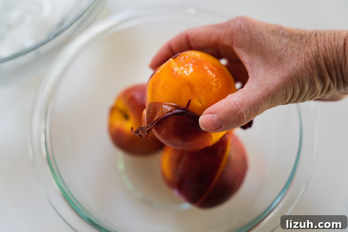 A fresh peach with the peel being removed.