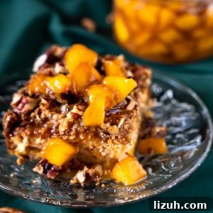 A serving of Fresh Peach Cobbler topped with Peach Bourbon sauce.
