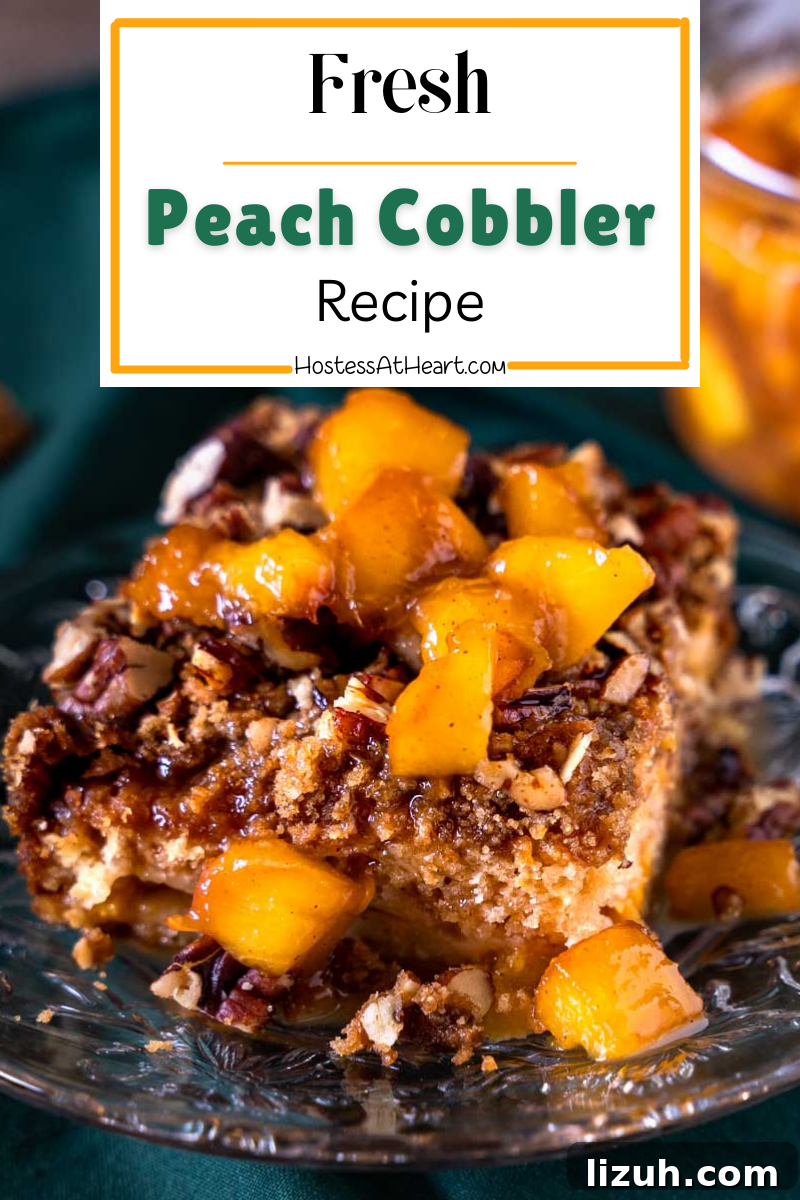 Table view of a serving of fresh peach cobbler topped with bourbon sauce.
