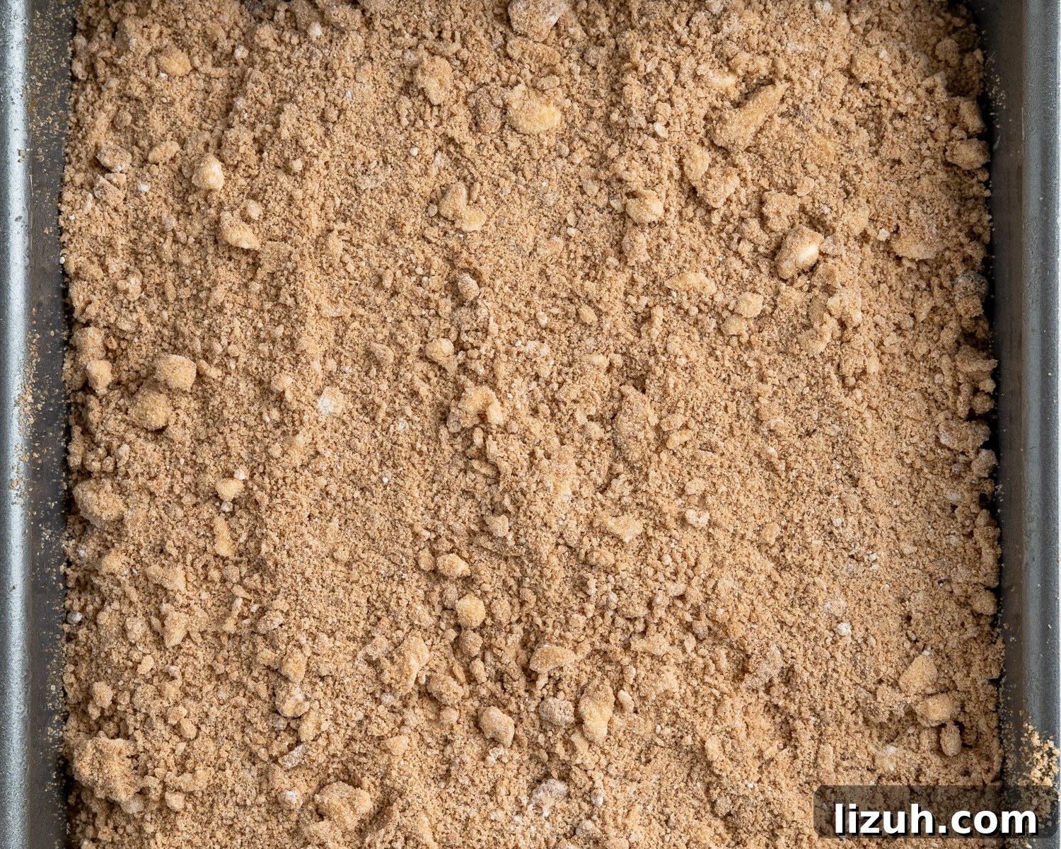 Top down view of a crumble topping for fresh peach crisp