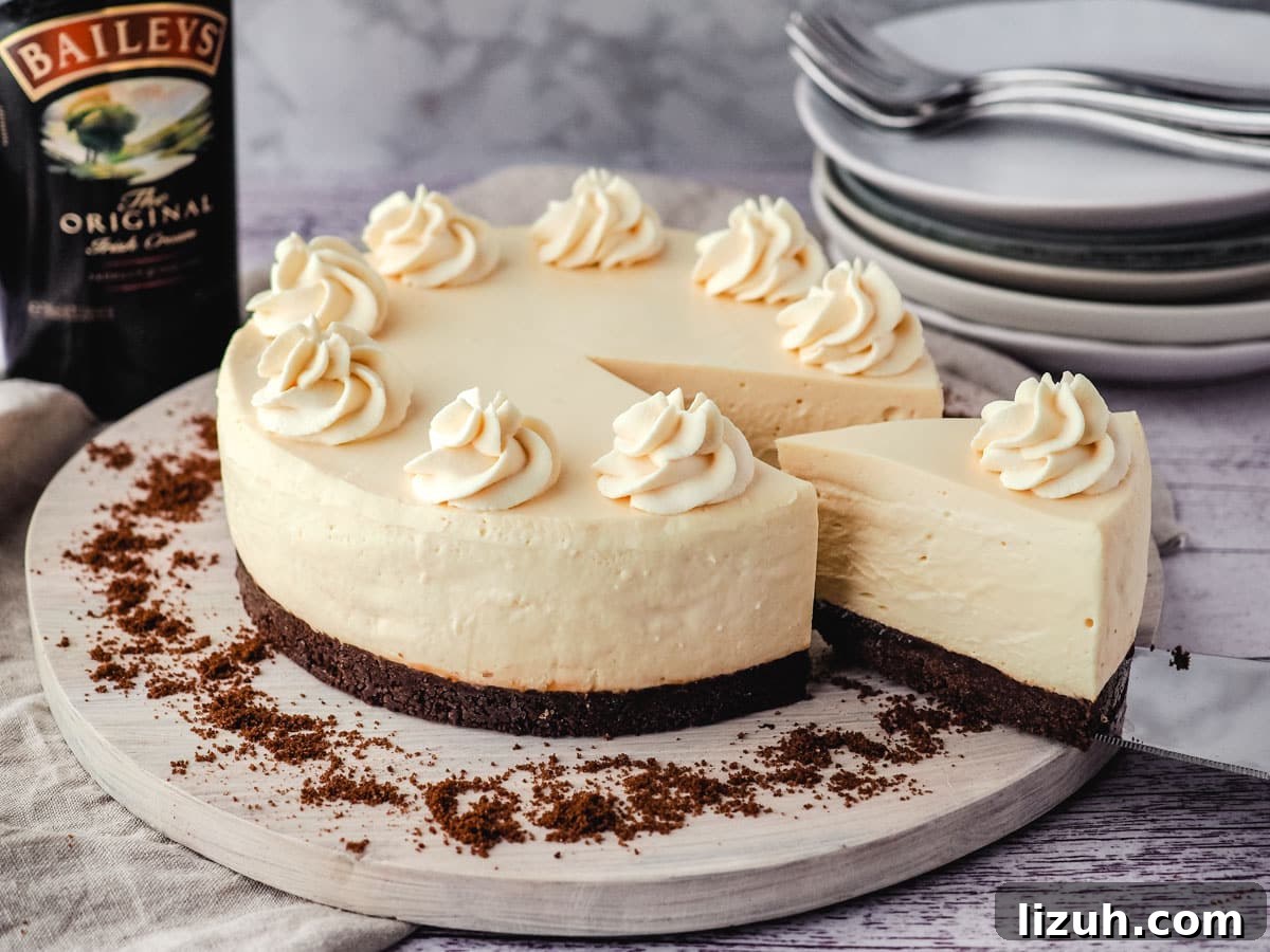 No-Bake Baileys Cheesecake Recipe: Creamy Irish Cream Dessert 8 Removing a slice of Baileys cheesecake.