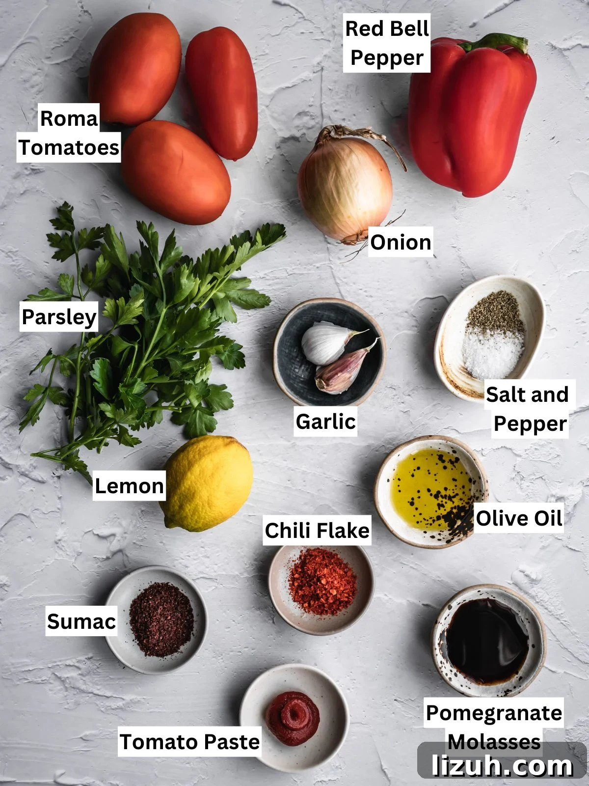 Turkish Ezme Salad recipe ingredients with individual labels on a board.