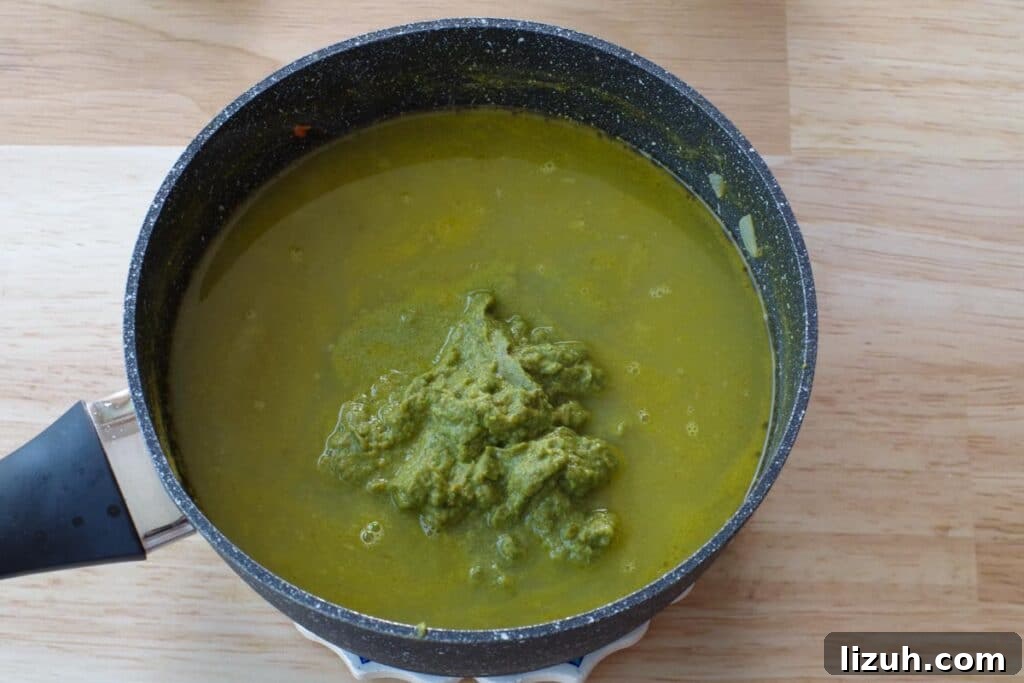 Creamy Fiddlehead and Cheese Soup Recipe 10 fiddlehead vegetable puree being whisked into soup