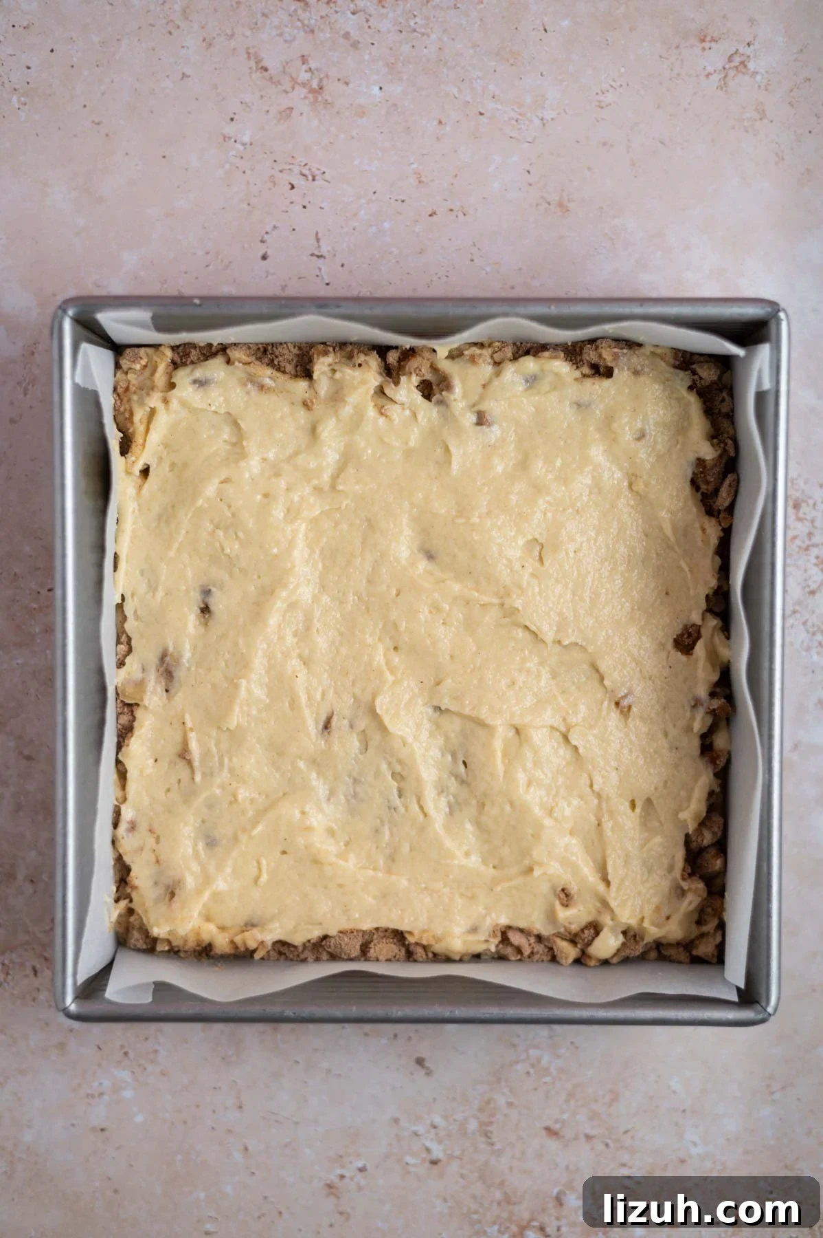 Cinnamon Walnut Coffee Cake Recipe for Weekend Baking 14 cake batter over streusel layer in a baking pan
