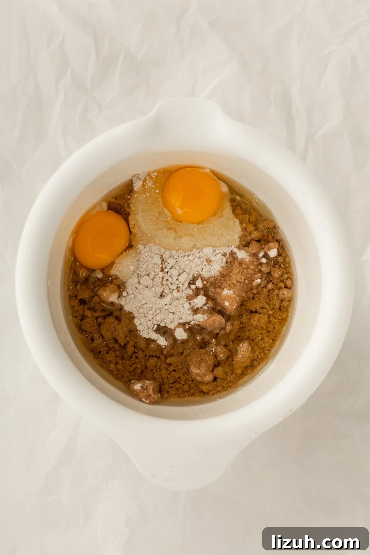 3-Ingredient Spice Cake Mix Cookies Recipe for Quick Treats 6 eggs, oil and cake mix in a mixing bowl.