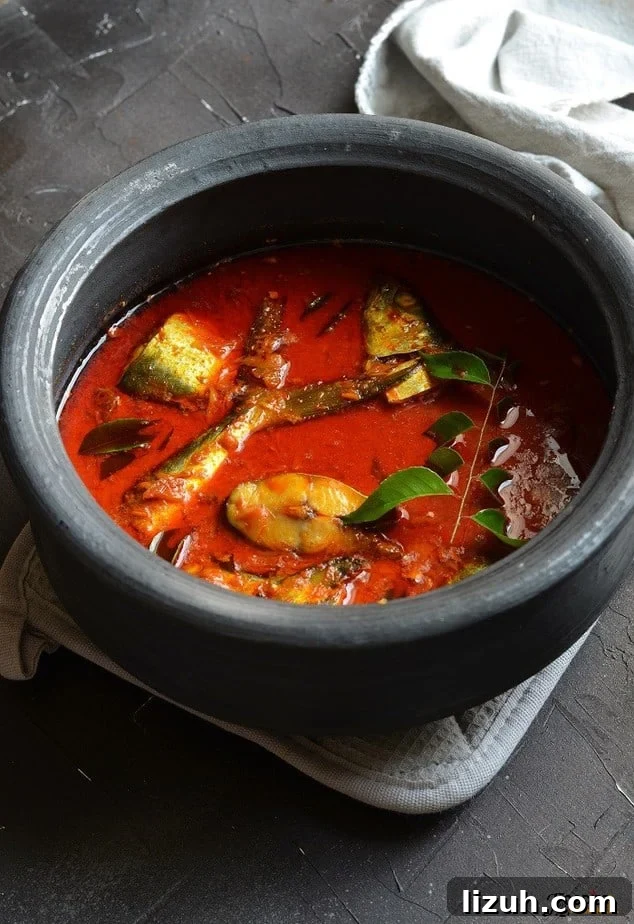 Kerala Coconut Fish Curry Recipe — Authentic Malabar Flavors 2 Kerala fish curry with coconut milk in a black earthen pot
