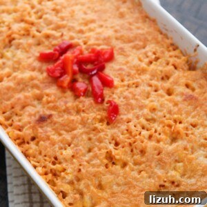 Imperial Rice: Creamy Baked Rice with Chicken and Shrimp 6 arroz imperial in a yellow casserole dish with melted yellow cheese and red peppers on the center.