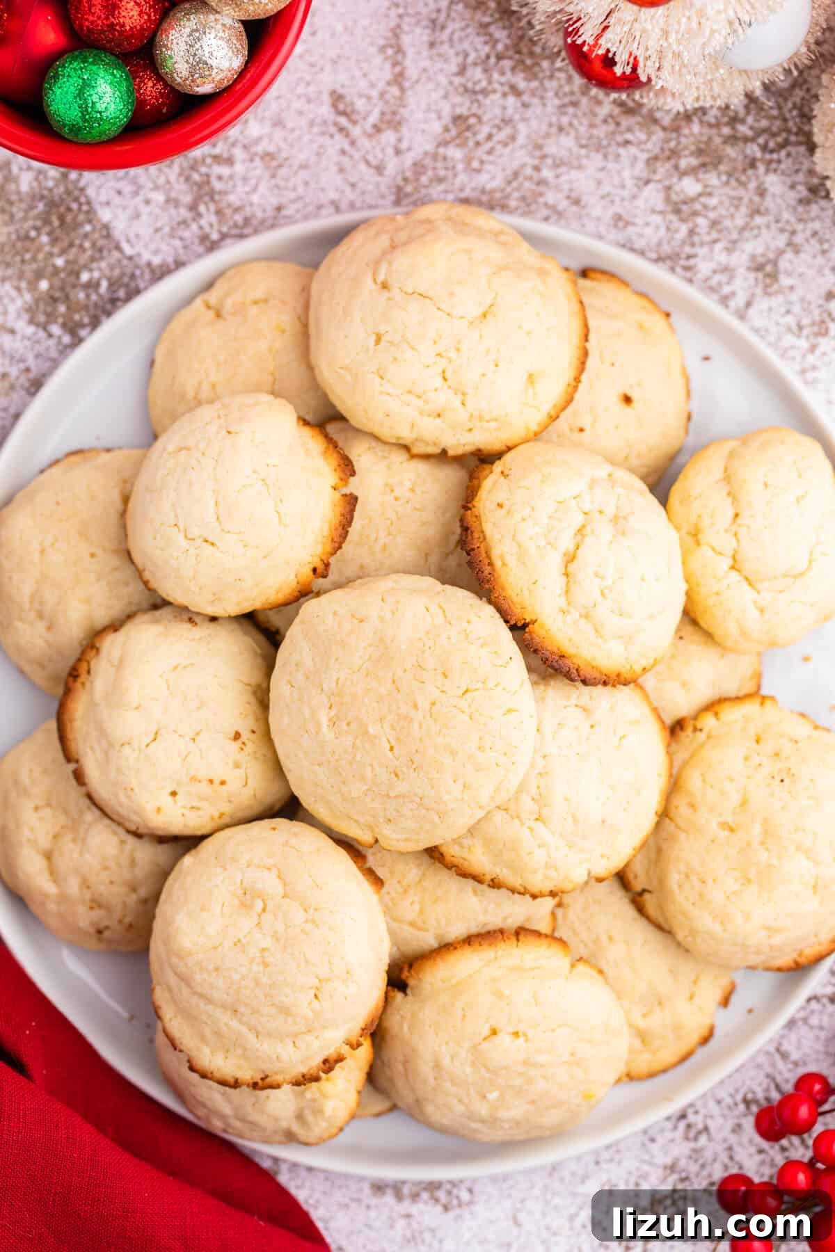 Soft and Chewy Cream Cheese Cookies — Simple Homemade Recipe 2 Cream cheese cookies on a plate.