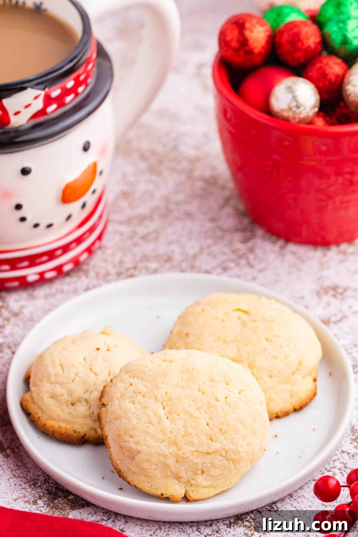 Soft and Chewy Cream Cheese Cookies — Simple Homemade Recipe 9 Three cookies on a plate.