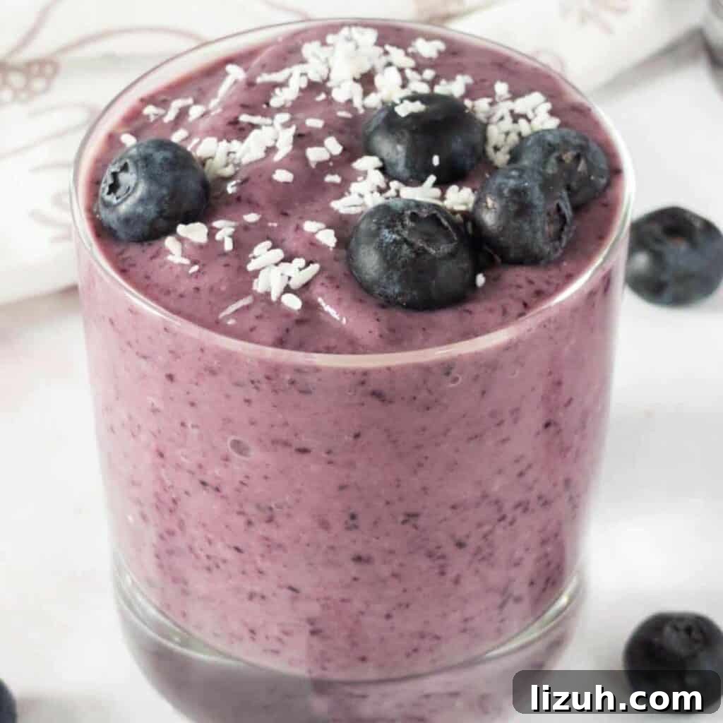 41 Perfect Side Dishes to Serve with Biscuits and Gravy 15 a glass cup full of blueberry avocado smoothie and blueberries on top.