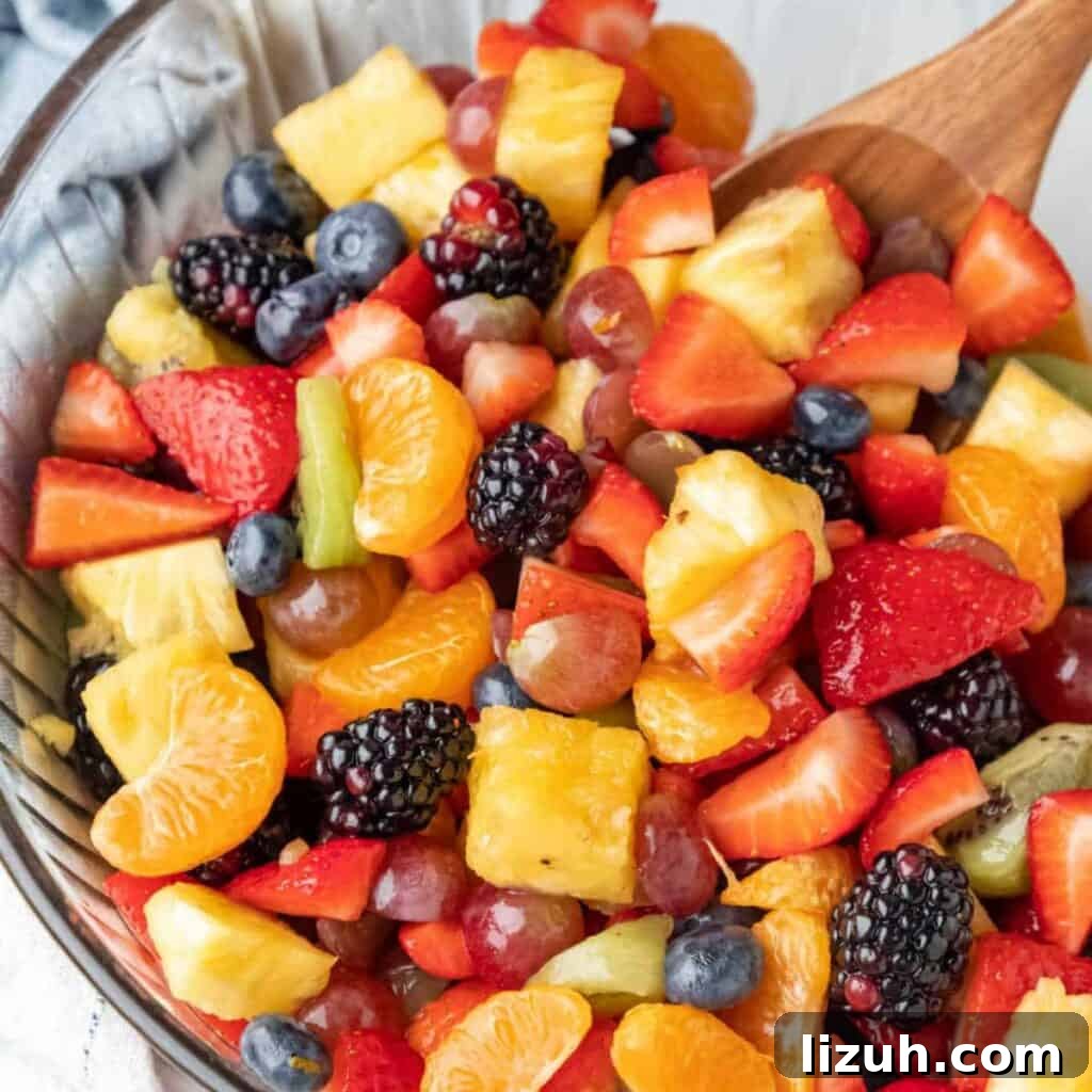 41 Perfect Side Dishes to Serve with Biscuits and Gravy 20 a bowl of delicious-looking fruit salad with lots of fresh fruit: berries, oranges, grapes, pineapple, etc..
