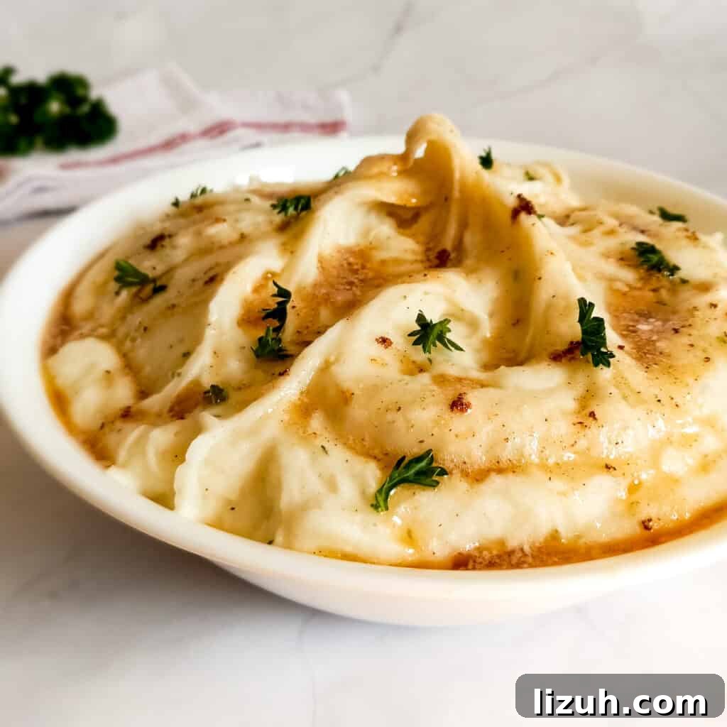 41 Perfect Side Dishes to Serve with Biscuits and Gravy 26 a bowl of creamy Amish mashed potatoes topped with brown butter and fresh parsley.
