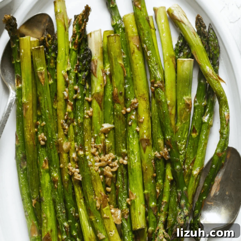 41 Perfect Side Dishes to Serve with Biscuits and Gravy 28 roasted asparagus on a plate.