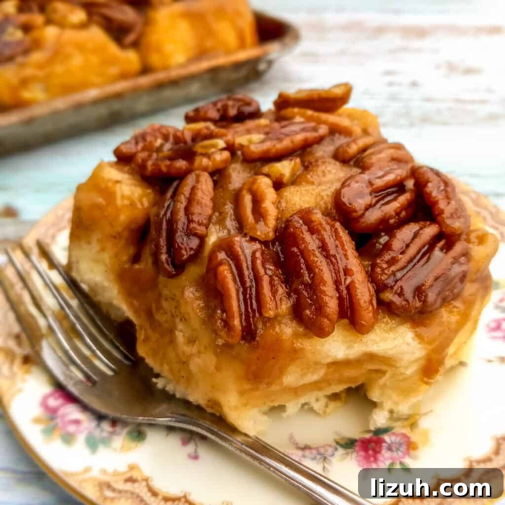 41 Perfect Side Dishes to Serve with Biscuits and Gravy 34 pecan-topped gooey Amish sticky bun on a plate ready to eat.