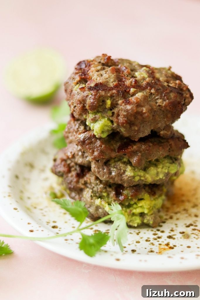 guacamole stuffed burgers fresh off the grill stacked with guacamole oozing out