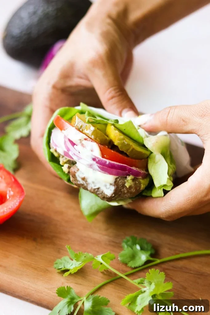 holding bunless stuffed burger 