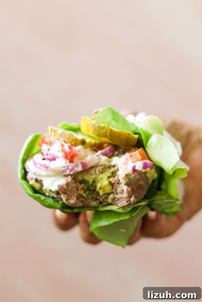 low carb burger in hand made with simple toppings