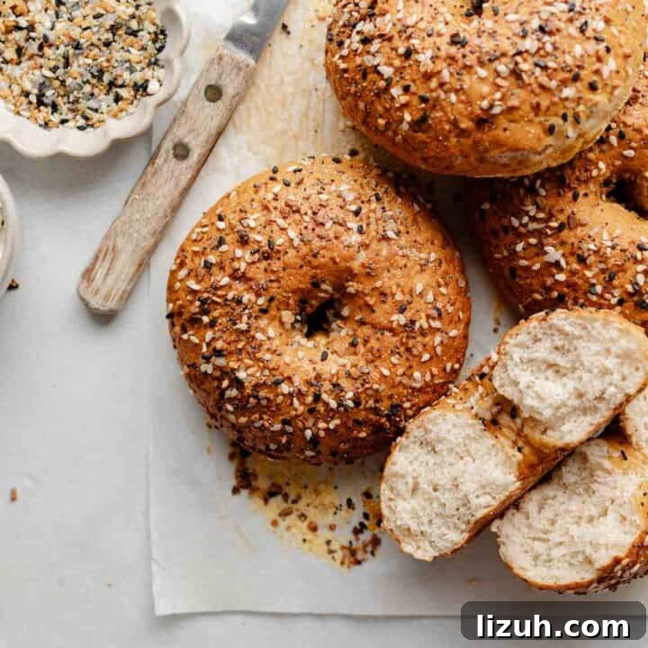 A close-up shot of a gluten-free bagel with a crispy, golden crust covered in everything bagel seasoning.