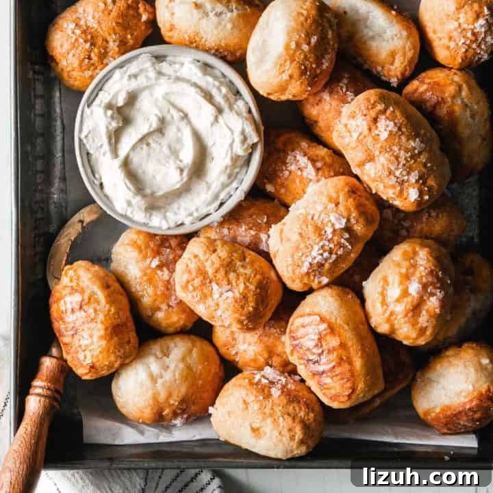 Gluten-free soft pretzel bites next to cream cheese.