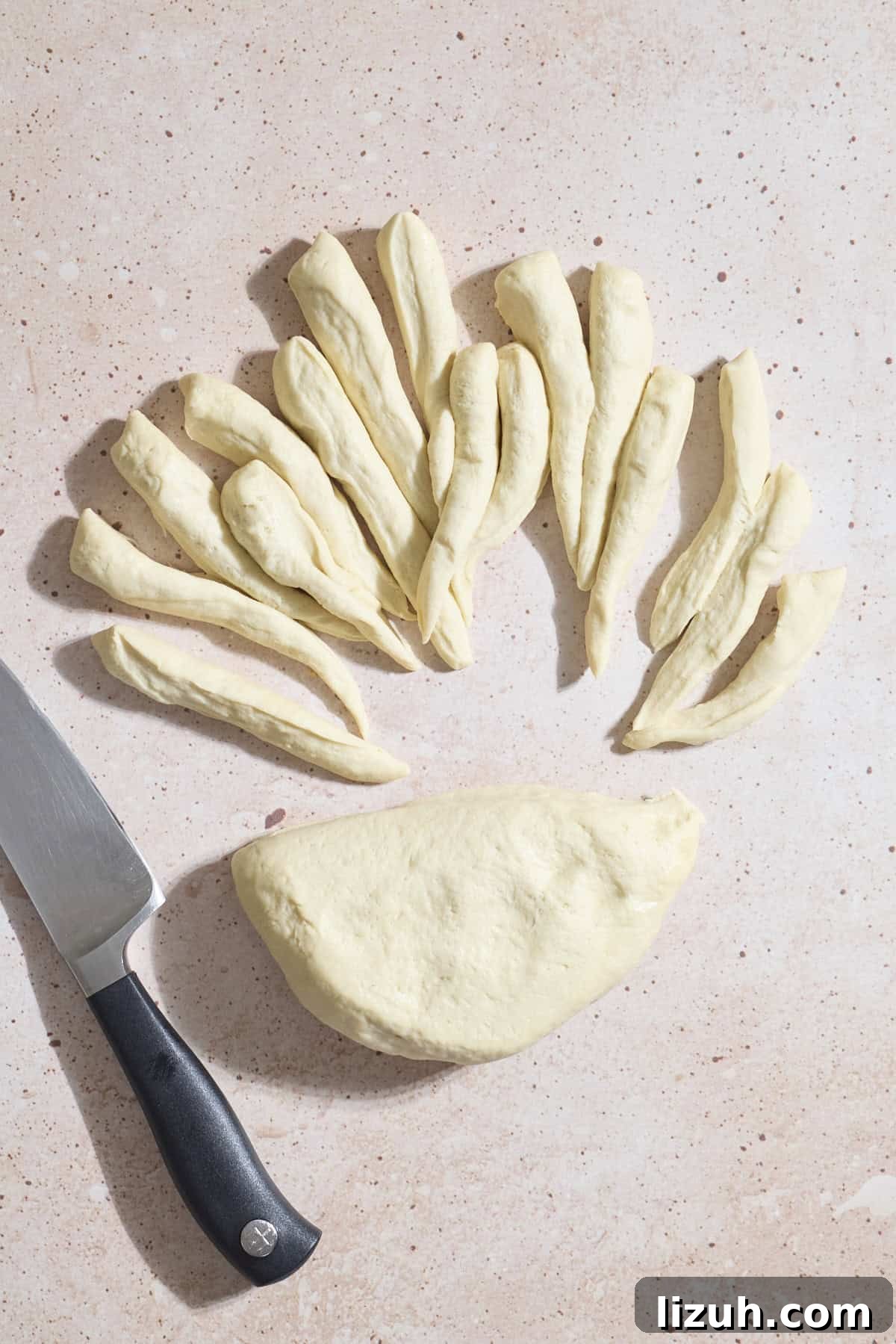 Sourdough Discard Pretzel Pigs in a Blanket Recipe 6 Dough being divided into portions.