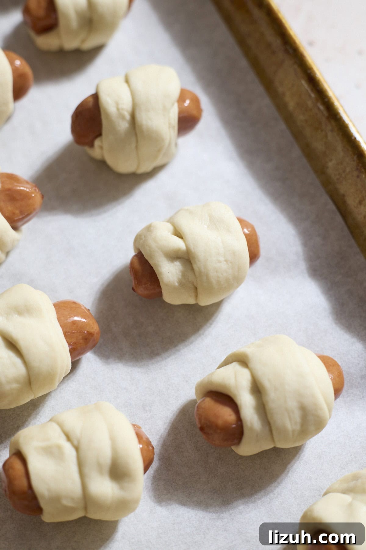 Sourdough Discard Pretzel Pigs in a Blanket Recipe 9 Dough wrapped around the cocktail sausages.