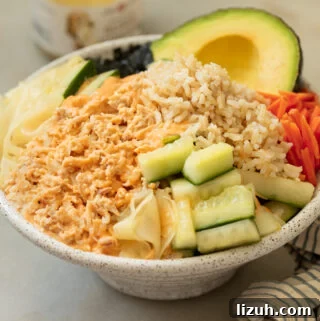 Spicy Tuna Poke Bowl Recipe — Quick Flavor-Packed Lunch 5 A tuna bowl with pickled cucmbers, carrots brown rice topped with spicy mayonnaise