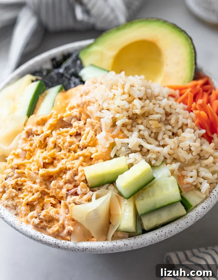 Spicy Tuna Poke Bowl Recipe — Quick Flavor-Packed Lunch 6 A tuna bowl with pickled cucmbers, carrots brown rice topped with spicy mayonnaise