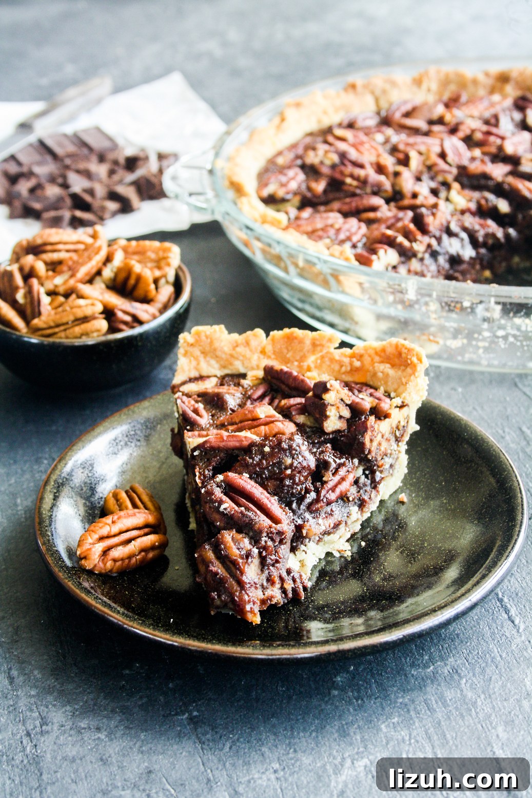 Rich and gooey dark chocolate pecan pie made with honey not corn syrup, on a homemade flaky pie crust
