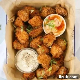 14-Day Meal Plan for Weight Loss and Balanced Nutrition 4 Coated golden homemade chicken nuggets in a baking dish with two pots of dips at the side.
