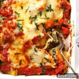 14-Day Meal Plan for Weight Loss and Balanced Nutrition 6 A dish with cooked Spinach and Ricotta Pasta Bake, topped with cheese, ready to be served.