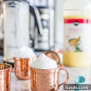 Eggnog Espresso Shooters: Holiday Coffee Cocktail Recipe 10 picture of copper shooter mug with foam on the countertop